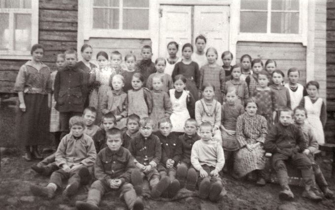 1922 uudelleen käynnistyneen kansakoulun oppilaat syksyllä 1923. Vasemmalla opettaja Martta Holck.